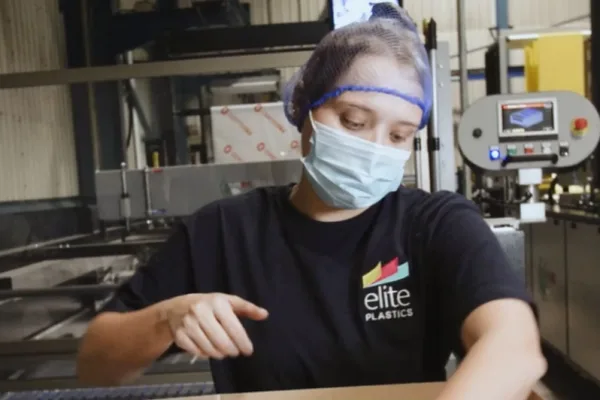 Elite Plastics employee at machinery