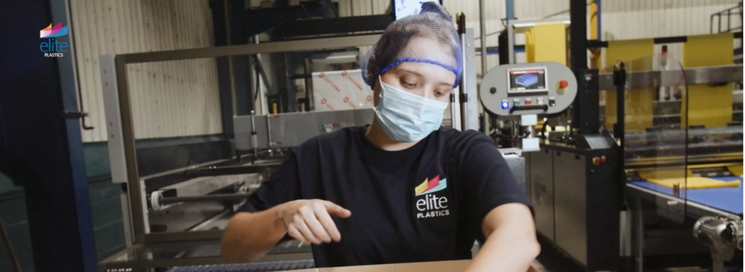 Elite Plastics employee at machinery