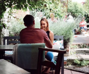 Two people conversing in a courtyard