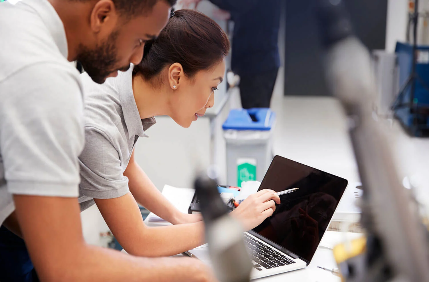 Two engineers at a laptop